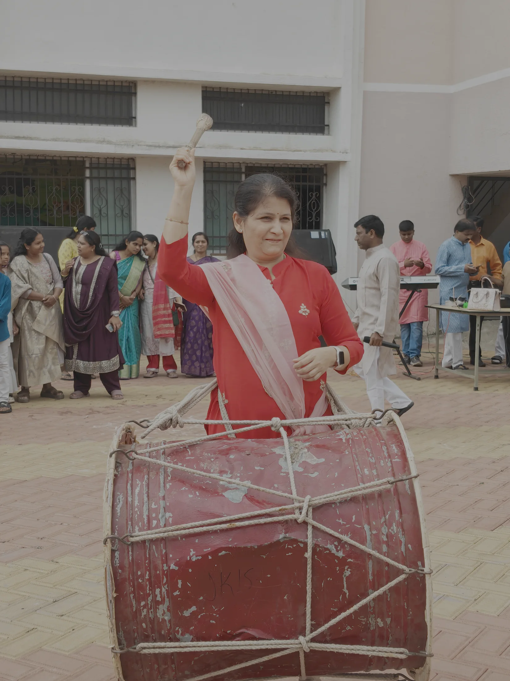 Educator playing dhol during the Ganpati celebration