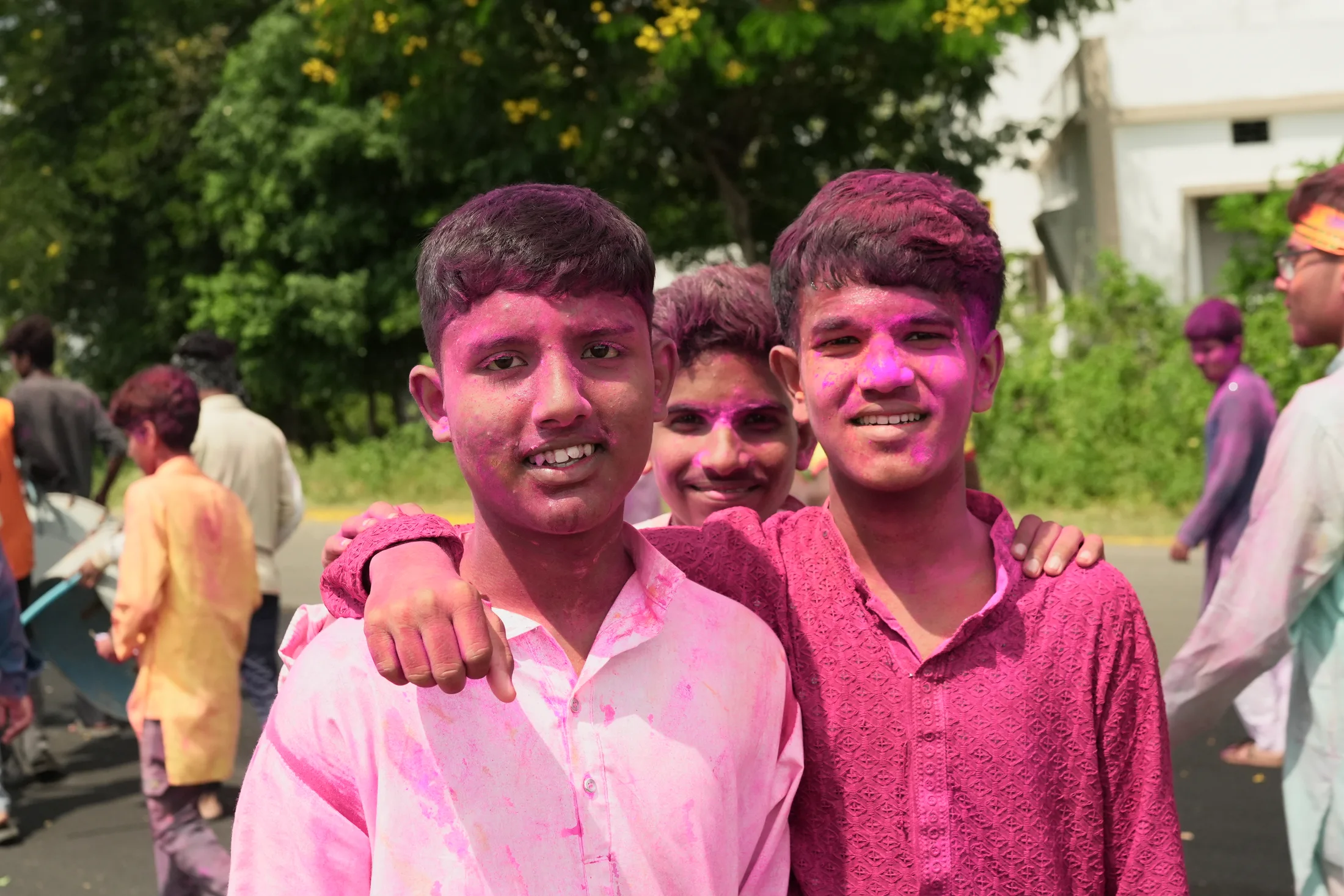 Students smiling with gulal