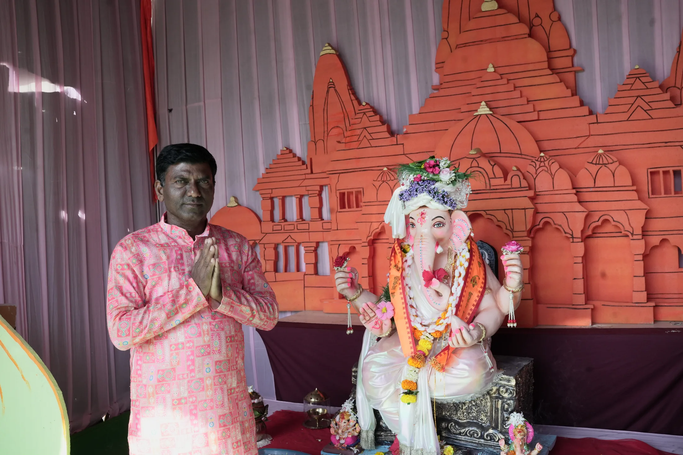 Decorated Ganpati idol on the Jet Kids stage with devotees offering prayers