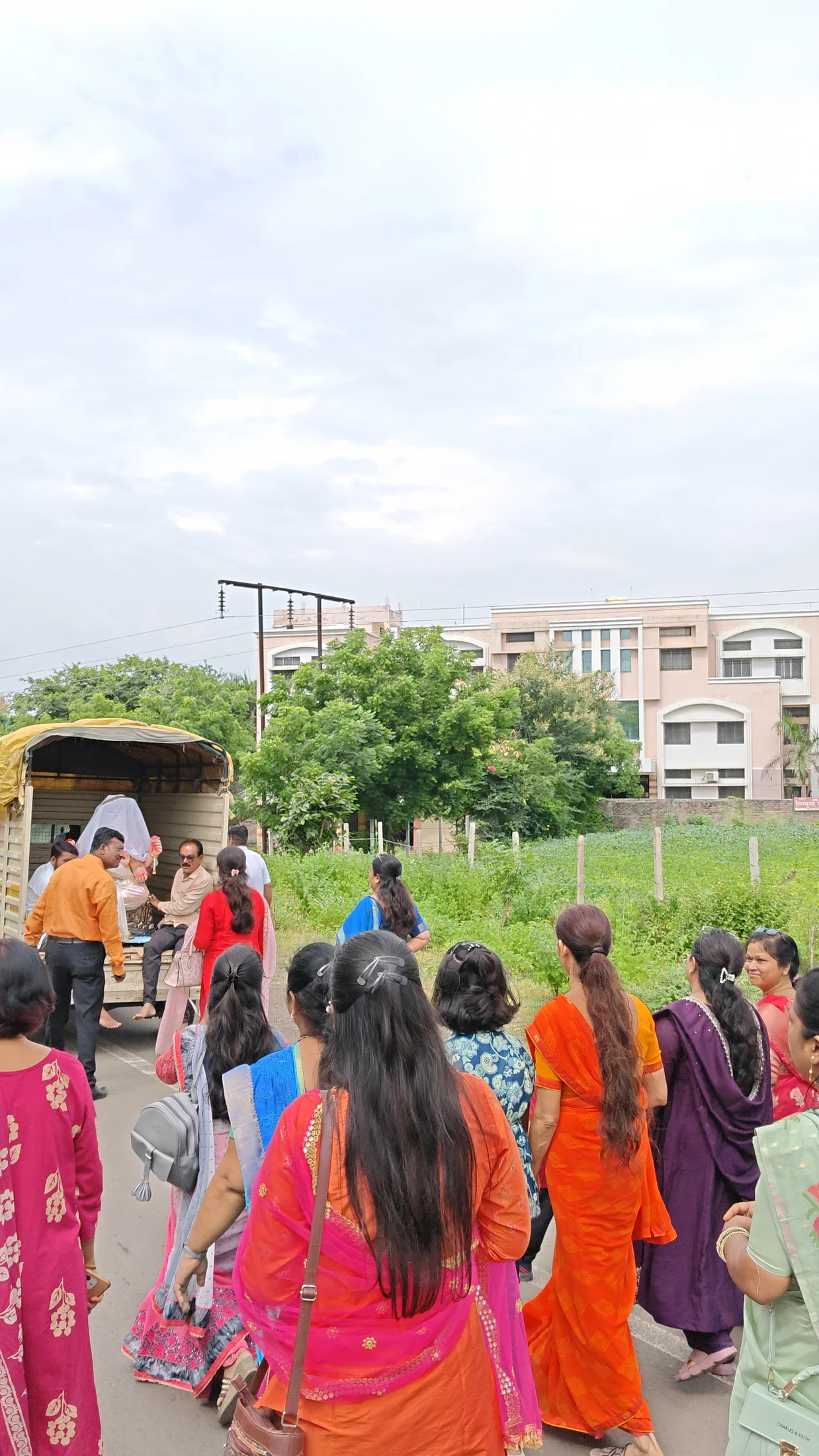 Saffron flags rising during the Ganpati arrival procession on campus