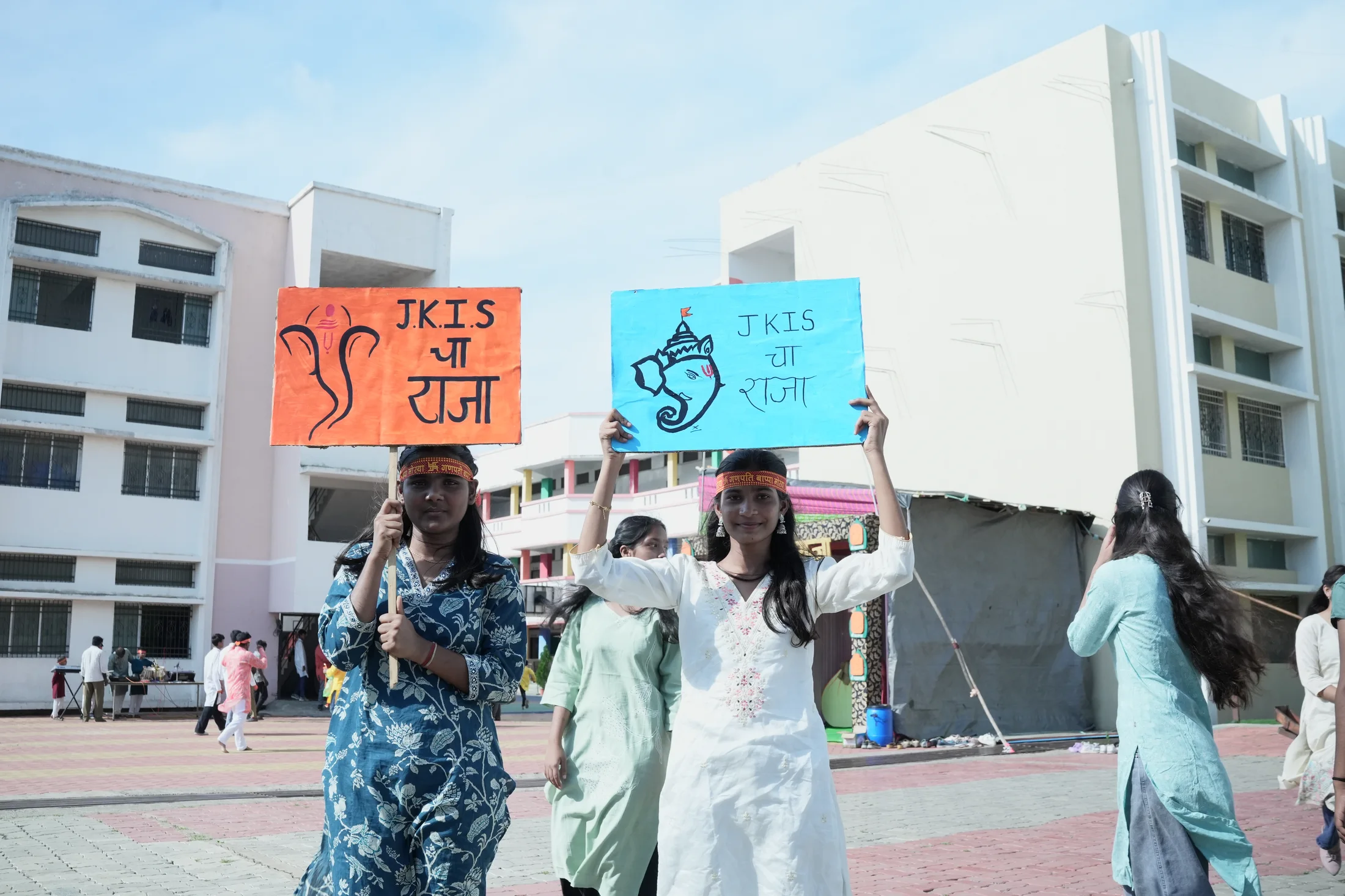 Students holding Ganpati welcome placards on campus
