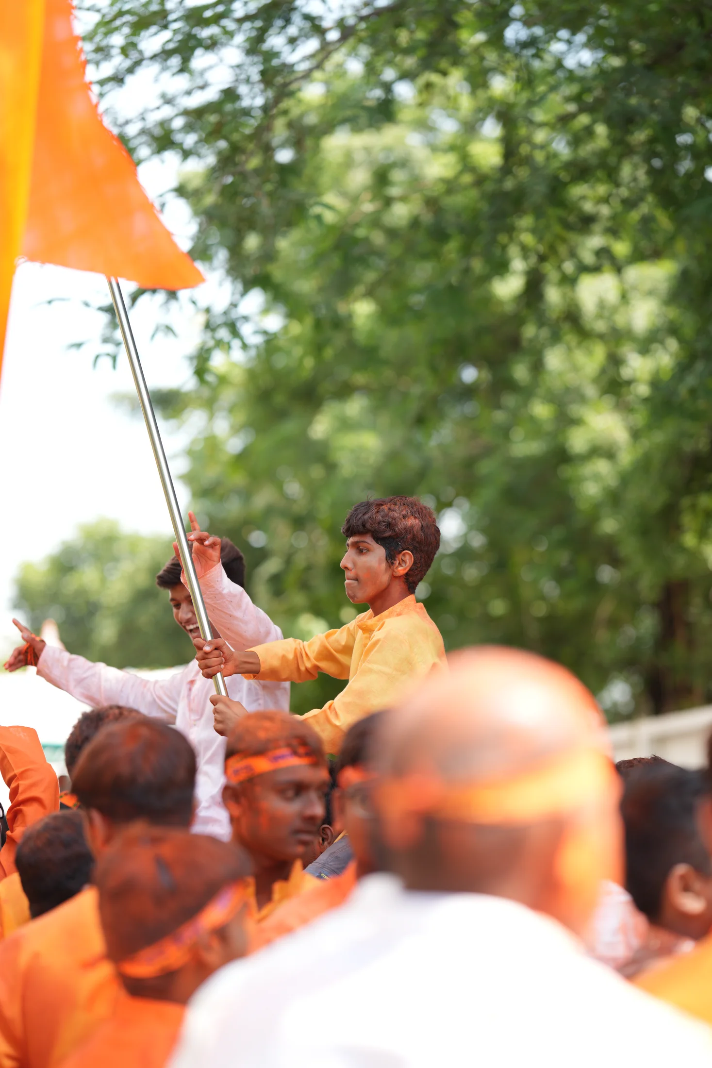 Student holding a saffron flag during Ganpati Visarjan