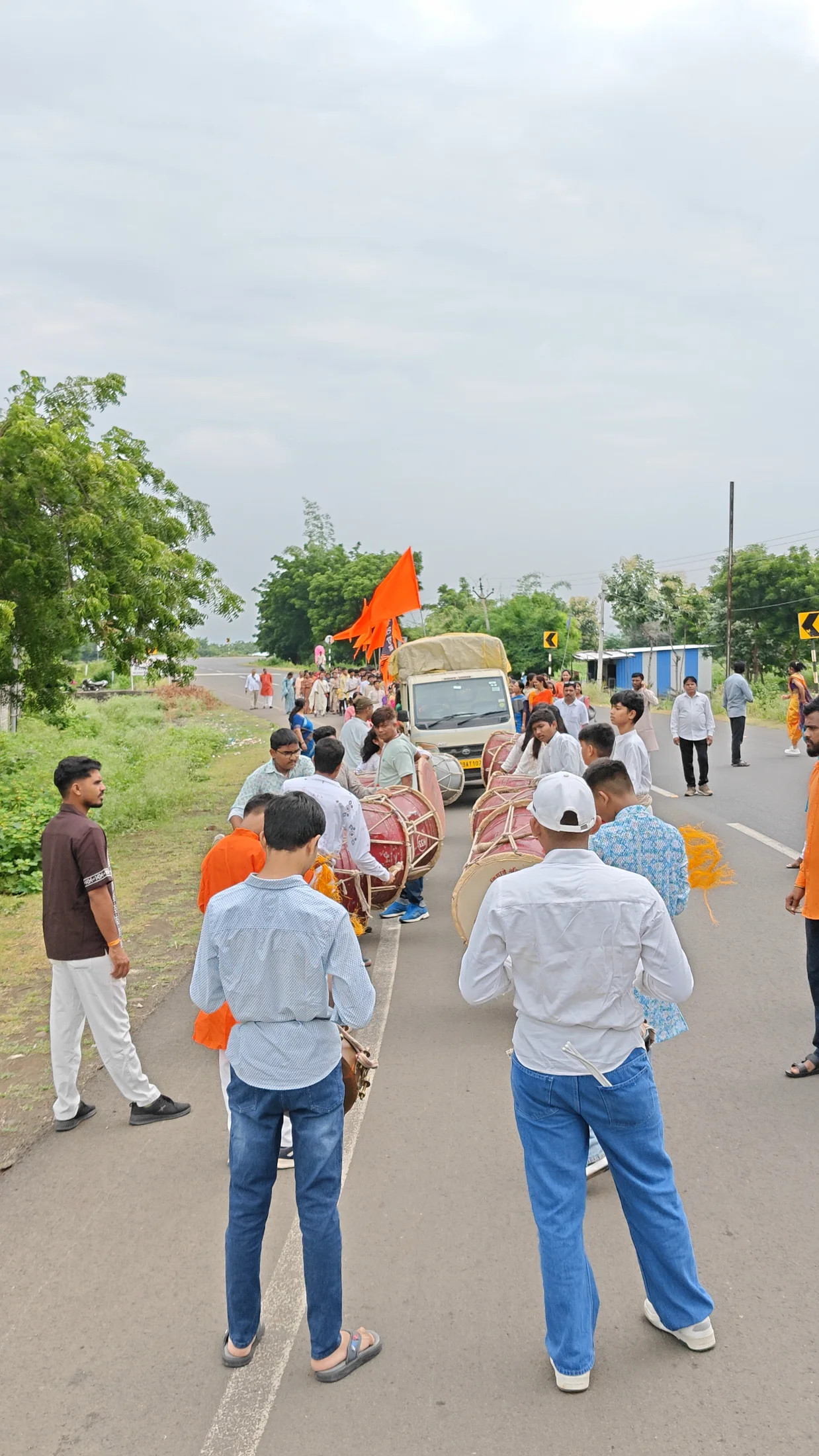Dhol players leading the Ganpati Visarjan procession on the road