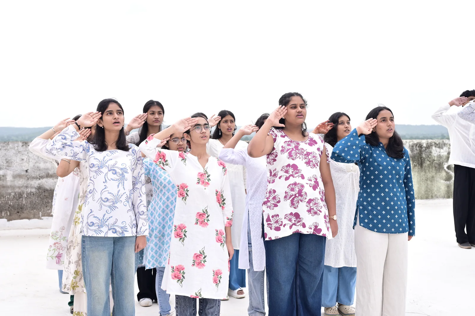 Girls cohort offering a crisp salute