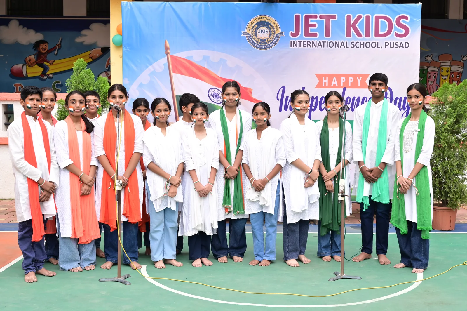 Full school choir in tricolour sashes